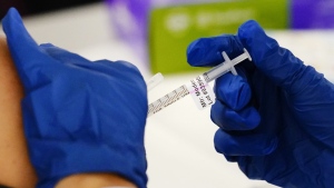 FILE - A health worker administers a dose of a Moderna COVID-19 vaccine during a vaccination clinic in Norristown, Pa., Tuesday, Dec. 7, 2021. (AP Photo/Matt Rourke, File)
