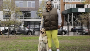 Suly Ortiz stands with her Labrador retriever at McCarren Park in the Brooklyn borough of New York, on Tuesday, April 26, 2022. Ortiz described her yellow Lab as "really calm, lazy and shy." Research released on Thursday, April 28, 2022, confirms what dog lovers know _ every pup is truly an individual. A new study has found that many of the popular stereotypes about the behavior of specific breeds aren’t supported by science. (AP Photo/Emma H. Tobin)