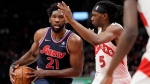 Philadelphia 76ers centre Joel Embiid (21) moves the ball under pressure from Toronto Raptors forward Precious Achiuwa (5) during second half NBA East Division 1st round game 6 basketball action in Toronto, Thursday, April 28, 2022. THE CANADIAN PRESS/Frank Gunn