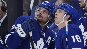 Toronto Maple Leafs centre Auston Matthews (34) watches the replay of his goal against the Detroit Red Wings with teammate right wing Mitchell Marner (16) during third period NHL hockey action in Toronto, Tuesday, April 26, 2022.  THE CANADIAN PRESS/Frank Gunn