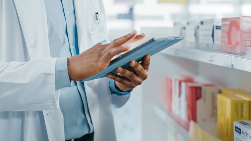 A pharmacist is seen checking inventory at an unknown pharmacy. (Shutterstock.com)
