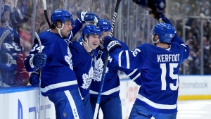 Toronto Maple Leafs forward Mitchell Marner (16) celebrates his goal with teammates Auston Matthews (34), Morgan Rielly (44) and Alexander Kerfoot (15) during second period, round one, NHL Stanley Cup playoff hockey action against the Tampa Bay Lightning, in Toronto, Monday, May 2, 2022. THE CANADIAN PRESS/Nathan Denette