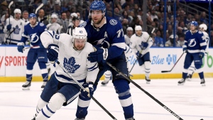 Toronto Maple Leafs left wing Kyle Clifford (43) and Tampa Bay Lightning defenseman Victor Hedman (77) fight for the puck during the second period of an NHL hockey game Monday, April 4, 2022, in Tampa, Fla. (AP Photo/Jason Behnken)