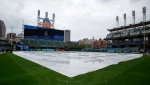 FILE - The tarp sits on the field after a baseball game between the San Diego Padres and the Cleveland Guardians was postponed, Tuesday, May 3, 2022, in Cleveland. (AP Photo/Ron Schwane) 