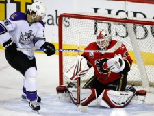 Calgary Flames' goalie Miikka Kiprusoff, from Finland, makes a save against Los Angeles Kings' Michal Handzus, left, from Slovakia, during third period NHL hockey action in Calgary on Thursday, Dec. 17, 2009 . (THE CANADIAN PRESS/Larry MacDougal)