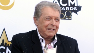 FILE - Mickey Gilley poses with the Triple Crown Award on the red carpet at the 50th annual Academy of Country Music Awards at AT&T Stadium in Arlington, Texas, April 19, 2015. Gilley, whose namesake Texas honky-tonk inspired the 1980 film 'Urban Cowboy,' and a nationwide wave of Western-themed nightspots, died Saturday, May 7, 2022, at age 86. (Photo by Jack Plunkett/Invision/AP, File)