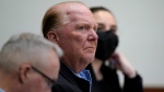 Celebrity chef Mario Batali, center, is seated next to defense attorney Anthony Fuller, left, at Boston Municipal Court for the first day of Batali's pandemic-delayed trial, Monday, May 9, 2022, in Boston. Batali pleaded not guilty to a charge of indecent assault and battery in 2019, stemming from accusations that he forcibly kissed and groped a woman after taking a selfie with her at a Boston restaurant in 2017. (AP Photo/Steven Senne, Pool)