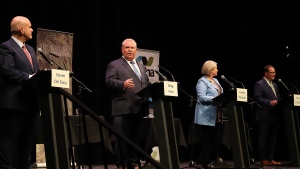 Ontario PC party leader Doug Ford makes a point at the Federation of Northern Ontario Municipalities debate at the Capitol Centre in North Bay, Ont. on Tuesday, May 10, 2022 as Liberal leader Steven Del Duca, NDP leader Andrea Horwath and Green Party leader Mike Schreiner look on. THE CANADIAN PRESS/Gino Donato
