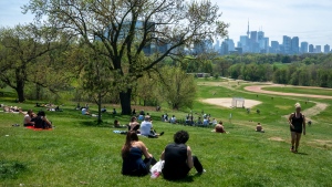 FILE -- Park visitors soak up the sun in Toronto on Saturday, May 23, 2020. Warm weather and a reduction in COVID-19 restrictions has many looking to the outdoors for relief. THE CANADIAN PRESS/Frank Gunn 