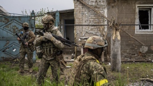 Ukrainian National Guard patrol during a reconnaissance mission in a recently retaken village on the outskirts of Kharkiv, east Ukraine, Saturday, May 14, 2022. (AP Photo/Bernat Armangue)