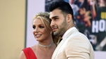 FILE - Britney Spears and Sam Asghari arrive at the Los Angeles premiere of "Once Upon a Time in Hollywood," at the TCL Chinese Theatre, Monday, July 22, 2019. Spears and her partner Asghari announced in a joint post on Instagram, Saturday, May 14, 2022, that they had lost their baby during pregnancy. The announcement came a little over a month after the couple revealed they were expecting a child. (Photo by Jordan Strauss/Invision/AP, File)