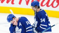 Toronto Maple Leafs forward Mitchell Marner (16) and teammate Auston Matthews (34) hands their heads after being knocked out of the NHL Stanley Cup playoffs in game seven from the Tampa Bay Lightning in Toronto on Saturday, May 14, 2022. THE CANADIAN PRESS/Nathan Denette