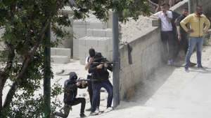 Palestinian gunmen take aim during an Israeli military operation in the West Bank town of Jenin, Friday, May 13, 2022. Daoud Zubeidi, a Palestinian gunman who is the brother of a prominent jailed Palestinian militant died Sunday after being critically wounded in clashes with Israeli forces, according to the Israeli hospital where he was being treated. (AP Photo/Majdi Mohammed, File)