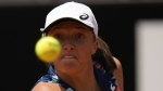 Poland's Iga Swiatek returns the ball to Turkey's Ons Jabeur during their final match at the Italian Open tennis tournament, in Rome, Sunday, May 15, 2022. (AP Photo/Alessandra Tarantino)