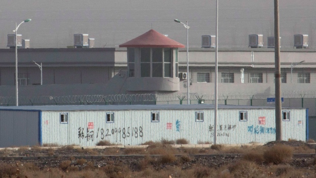 In this Monday, Dec. 3, 2018, file photo, a guard tower and barbed wire fences are seen around a facility in the Kunshan Industrial Park in Artux in western China's Xinjiang region.  In 2017, Samira Imin, a young Uighur Muslim woman working in Boston, last heard from her father, Iminjan Seydin, back home in China. In September 2019 she discovered that he had been kept in a government detention center, like over a million members of the beleaguered ethnic minority in China, before being sentenced to 15 years in prison in a closed trial. (Aysha Khan/RNS via AP)  (AP Photo/Ng Han Guan, File)