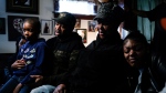 Wayne Jones, center left, accompanied by his aunt JoAnn Daniels, center right, son Donell Jones, left, and daughter Kayla Jones, speaks during an interview with The Associated Press, Monday, May 16, 2022, about his mother, Celestine Chaney, who was killed at the shooting at a supermarket over the weekend, in Buffalo, N.Y. (AP Photo/Matt Rourke)