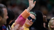 Soccer player Megan Rapinoe waves to the crowd during the second quarter of a WNBA basketball game between the Minnesota Lynx and the Seattle Storm on Friday, May 6, 2022, in Seattle. Rapinoe's fiancee, Sue Bird, plays for the Storm. (Jennifer Buchanan/The Seattle Times via AP)