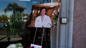 A photo of Dr. John Cheng, a 52-year-old victim who was killed in Sunday's shooting at Geneva Presbyterian Church, is displayed outside his office in Aliso Viejo, Calif., Monday, May 16, 2022. Authorities say a Chinese-born gunman was motivated by hatred against Taiwan when he chained shut the doors of the church and hid firebombs before shooting at a gathering of mainly of elderly Taiwanese parishioners. (AP Photo/Jae C. Hong)