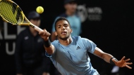 Felix Auger-Aliassime of Canada returns the ball to Novak Djokovic of Serbia during their match at the Italian Open tennis tournament, in Rome, Friday, May 13, 2022. THE CANADIAN PRESS/AP-Andrew Medichini