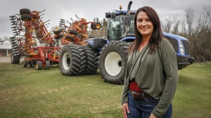 Due to the rising costs of fuel and fertilizer farmers like Tara Sawyer, pictured at her family's farm near Acme, Alta., Tuesday, May 17, 2022, say this will be the most expensive crop in Canadian history. THE CANADIAN PRESS/Jeff McIntosh