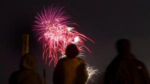 People watch the Toronto Victoria Day fireworks on the beach on Monday, May 20, 2013. THE CANADIAN PRESS/Chris Young