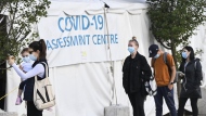 People wait in line at a COVID assessment centre at Women's College Hospital on Wednesday, September 23, 2020. Nearly 1,000 confirmed cases of a new sublineage of the Omicron variant have been discovered in Ontario, but experts say it doesn't warrant significant concern.THE CANADIAN PRESS/Nathan Denette