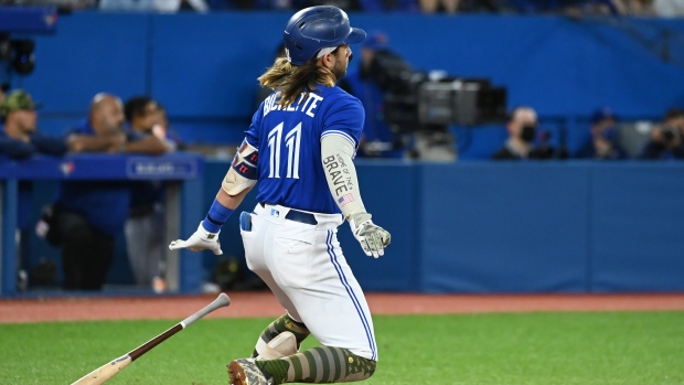 Toronto Blue Jays' Bo Bichette watches his RBI double, scoring George Springer, not shown, in the fifth inning of an Interleague League baseball game against the Cincinnati Reds in Toronto on Friday, May 20, 2022. THE CANADIAN PRESS/Jon Blacker