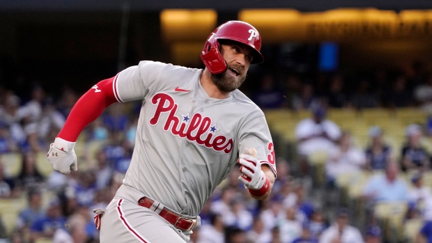 Philadelphia Phillies' Bryce Harper rounds first on his way to a double during the first inning of a baseball game against the Los Angeles Dodgers Saturday, May 14, 2022, in Los Angeles. (AP Photo/Mark J. Terrill)