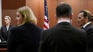 Actor Amber Heard, left, and actor Johnny Depp appear in the courtroom during a break at the Fairfax County Circuit Courthouse in Fairfax, Va., Tuesday, May 17, 2022. Depp sued his ex-wife Amber Heard for libel in Fairfax County Circuit Court after she wrote an op-ed piece in The Washington Post in 2018 referring to herself as a "public figure representing domestic abuse." (Brendan Smialowski/Pool photo via AP)