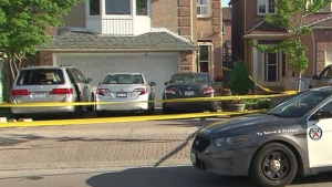Damaged vehicles and police tape are seen in Scarborough after a stabbing on May 23, 2022. (CP24)