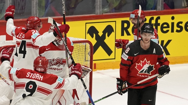 Denmark's players celebrate beside Canada's Damon Severson, right, after winning the group A Hockey World Championship match between Canada and Denmark in Helsinki, Finland, Monday May 23 2022. THE CANADIAN PRESS/AP/Martin Meissner