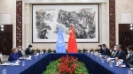 In this photo released by Xinhua News Agency, Chinese Foreign Minister Wang Yi, second right, meets with the United Nations High Commissioner for Human Rights Michelle Bachelet, left, in Guangzhou, southern China's Guangdong Province on Monday, May 23, 2022. China opposes "politicizing" human rights and imposing double standards, its foreign minister said in comments at the start of a visit by a top United Nations official focused on allegations of abuses against Muslim minorities in the northwestern region of Xinjiang. (Deng Hua/Xinhua via AP)