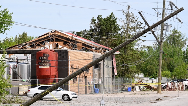 Fallen hydro wires and property damages are seen in Uxbridge, Ont., on Tuesday, May 24, 2022, after a major storm hit parts of Ontario on Saturday, May 21, 2022, leaving extensive damage. THE CANADIAN PRESS/Jon Blacker