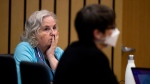 Romance writer Nancy Crampton Brophy, left, accused of killing her husband, Dan Brophy, in June 2018, watches proceedings in court in Portland, Ore., Monday, April 4, 2022.  (Dave Killen/The Oregonian via AP, Pool, File Photo) 