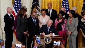President Joe Biden signs an executive order in the East Room of the White House, Wednesday, May 25, 2022, in Washington. The order comes on the second anniversary of George Floyd's death, and is focused on policing. (AP Photo/Alex Brandon)