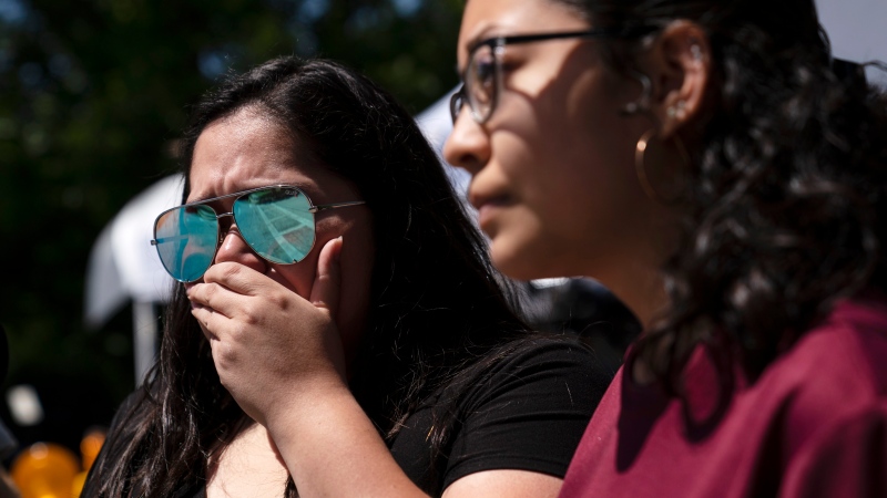 Stefanie Garcia, 28, left, breaks down as she visits Robb Elementary School to pay her respects in Uvalde, Texas, Wednesday, May 25, 2022. Desperation turned to heart-wrenching sorrow for families of grade schoolers killed after an 18-year-old gunman barricaded himself in their Texas classroom and began shooting, killing at least 19 fourth-graders and their two teachers. (AP Photo/Jae C. Hong)