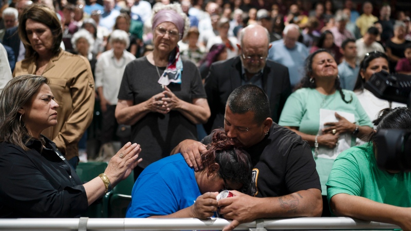 Two family members of one of the victims killed in Tuesday's shooting at Robb Elementary School comfort each other during a prayer vigil in Uvalde, Texas, Wednesday, May 25, 2022. (AP Photo/Jae C. Hong)