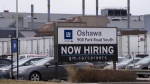 A sign announcing hiring sits at the General Motors facility in Oshawa, Ontario on Monday April 4, 2022. Statistics Canada says the number of job vacancies reached an all-time high in March even as the number of people working in retail surpassed its pre-pandemic level for the first time in the month. THE CANADIAN PRESS/Frank Gunn