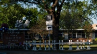 Crosses bearing the names of Tuesday's shooting victims are placed outside Robb Elementary School in Uvalde, Texas, Thursday, May 26, 2022. (AP Photo/Jae C. Hong)
