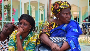 Relatives sit outside the Abdoul Aziz Sy Dabakh Hospital in Tivaouane, Senegal, a town 90 kms ( 60 miles) east of Dakar Thursday, May 26, 2022. Senegal's president says 11 newborns have died in a fire that broke out in the neonatal unit of a hospital. Authorities in the town of Tivaouane said only three babies could be saved after a short circuit caused the blaze. (AP Photo/Cheik Sy)