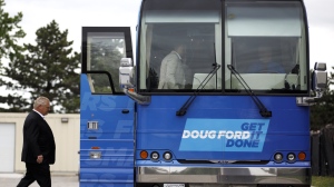 Ontario Progressive Conservative Leader Doug Ford boards his bus as he leaves a press conference at the HVAC-R training facility in Brampton, Ont. Wednesday, May 25, 2022 in Toronto. THE CANADIAN PRESS/Cole Burston