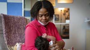 Capri Isidoro, of Ellicott City, Md., looks at her one-month-old baby Charlotte, Monday, May 23, 2022, in Columbia, Md., during a lactation consultation. Charlotte was delivered via emergency c-section and given formula by hospital staff. Isidoro has been having trouble with breastfeeding and has been searching for a formula that her daughter can tolerate well. "If all things were equal I would feed her with formula and breastmilk," says Isidoro, "but the formula shortage is so scary. I worry I won't be able to feed my child." (AP Photo/Jacquelyn Martin)