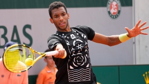 Canada's Felix Auger-Aliassime returns the ball to Serbia's Filip Krajinovic during their third round match of the French Open tennis tournament at the Roland Garros stadium Friday, May 27, 2022 in Paris. (AP Photo/Michel Euler)