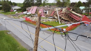 The debris from a building in an adjacent lumber yard is pictured in an image made using a drone in a neighbourhood in Hammond, Ont., on Thursday, May 26, 2022. A major storm hit parts of Ontario and Quebec on Saturday, May 21, 2022, killing 11 people and leaving extensive damage to infrastructure, homes, and business. THE CANADIAN PRESS/Sean Kilpatrick
