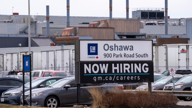 A sign announcing hiring sits at the General Motors facility in Oshawa, Ontario on Monday April 4, 2022. THE CANADIAN PRESS/Frank Gunn