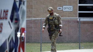 A Texas State Police officer walks outside Robb Elementary School following a shooting, Tuesday, May 24, 2022, in Uvalde, Texas. (AP Photo/Dario Lopez-Mills)