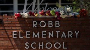 Flowers are placed around a welcome sign outside Robb Elementary School in Uvalde, Texas, Wednesday, May 25, 2022, to honor the victims killed in Tuesday's shooting at the school. Desperation turned to heart-wrenching sorrow for families of grade schoolers killed after an 18-year-old gunman barricaded himself in their Texas classroom and began shooting, killing several fourth-graders and their teachers. (AP Photo/Jae C. Hong) 