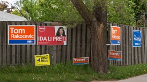 Signs for candidates for the 2022 Ontario general election, adorn a fence in Toronto on Wednesday, May 25, 2022. THE CANADIAN PRESS/Chris Young