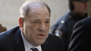 FILE - Harvey Weinstein arrives at a Manhattan court in New York, as jury deliberations continue in his rape trial, Feb. 21, 2020. British prosecutors say they have authorized police to charge ex-film producer Harvey Weinstein with two counts of indecent assault against a woman in London in 1996. The Crown Prosecution Service said in a statement “charges have been authorized” against Weinstein, 70, following a review of evidence gathered by London’s Metropolitan Police in its investigation. (AP Photo/Mark Lennihan, File)