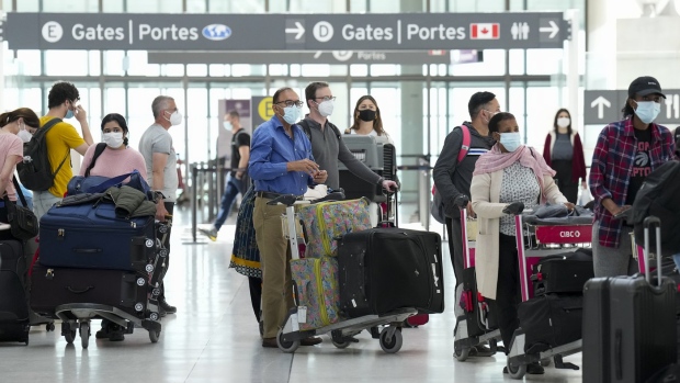 People wait in line to check in at Pearson International Airport in Toronto on Thursday, May 12, 2022. THE CANADIAN PRESS/Nathan Denette